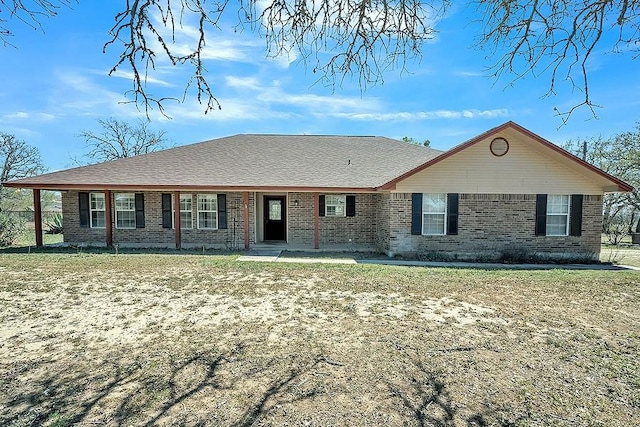 single story home with a front yard and brick siding