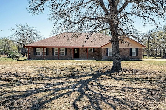 ranch-style house with brick siding and a front lawn