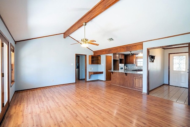 unfurnished living room with visible vents, vaulted ceiling with beams, baseboards, ceiling fan, and light wood-style flooring