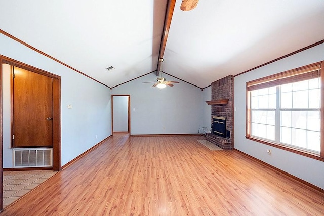 unfurnished living room with visible vents, lofted ceiling with beams, a fireplace, ceiling fan, and light wood-style floors