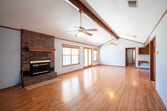 unfurnished living room featuring lofted ceiling with beams, visible vents, light wood-type flooring, and a ceiling fan