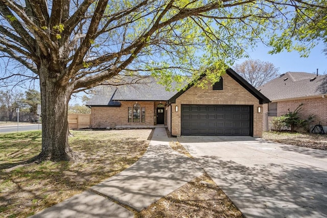 11107 Amblewood Way, Austin, TX 78753 - view of front of property with brick siding, an attached garage, and concrete driveway