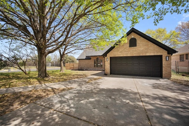 11107 Amblewood Way, Austin, TX 78753 - view of front of house with brick siding, concrete driveway, and an attached garage