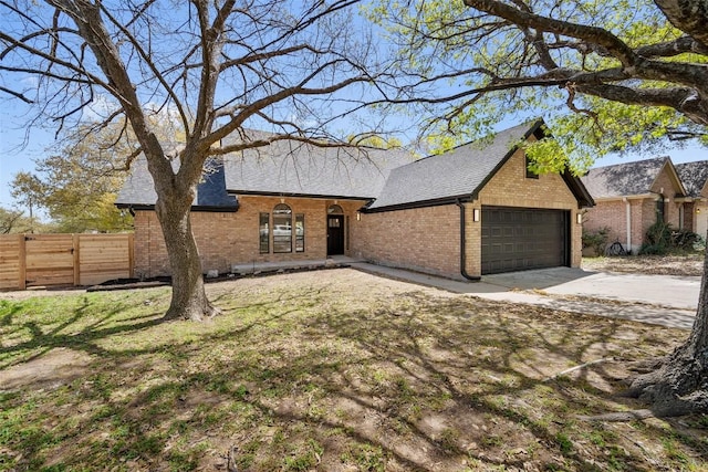 11107 Amblewood Way, Austin, TX 78753 - view of front of property with brick siding, concrete driveway, a garage, and a shingled roof