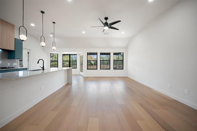 11107 Amblewood Way, Austin, TX 78753 - unfurnished living room featuring a sink, light wood-type flooring, a ceiling fan, recessed lighting, and baseboards