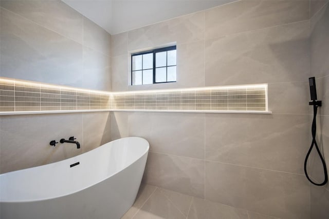 11107 Amblewood Way, Austin, TX 78753 - bathroom featuring a freestanding bath, tile patterned flooring, and a tile shower