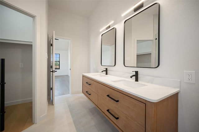 11107 Amblewood Way, Austin, TX 78753 - bathroom featuring double vanity and baseboards
