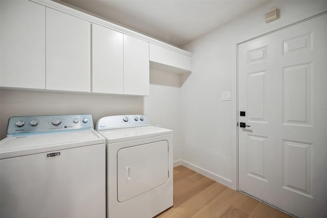 11107 Amblewood Way, Austin, TX 78753 - washroom with separate washer and dryer, light wood-type flooring, cabinet space, and baseboards