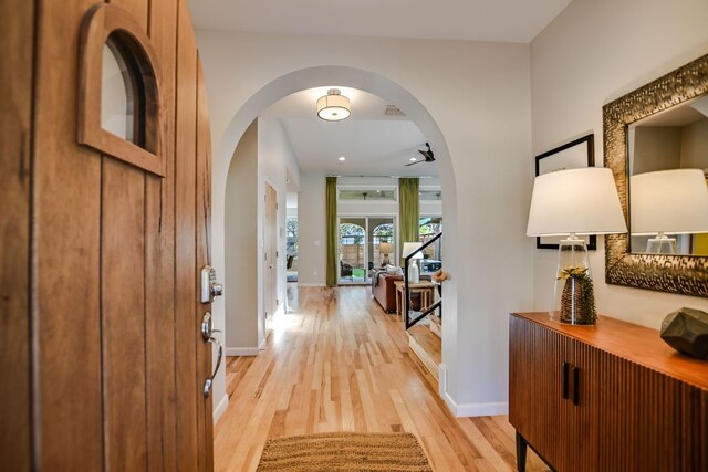 1609 Palma Plz, Austin, TX 78703 - entryway with arched walkways, light wood-type flooring, and baseboards