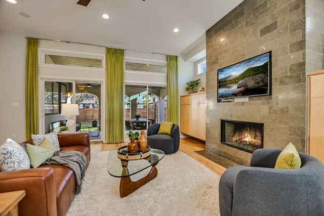 living area featuring recessed lighting, a ceiling fan, wood finished floors, and a fireplace