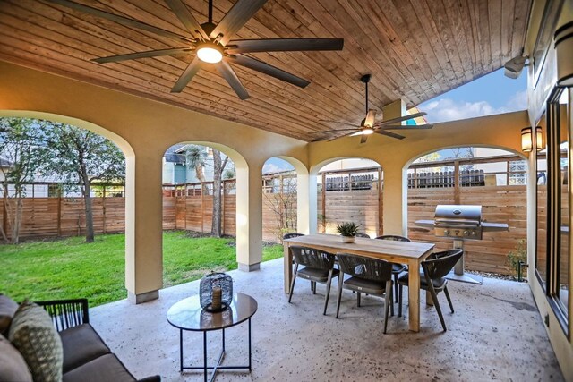view of patio / terrace featuring a fenced backyard, a ceiling fan, outdoor dining space, and grilling area