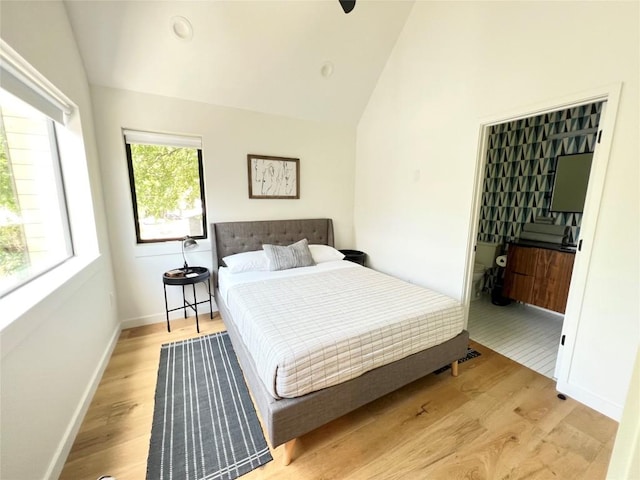 1100 Brass St Unit 2, Austin, TX 78702 - bedroom featuring vaulted ceiling, light wood finished floors, baseboards, and ensuite bathroom