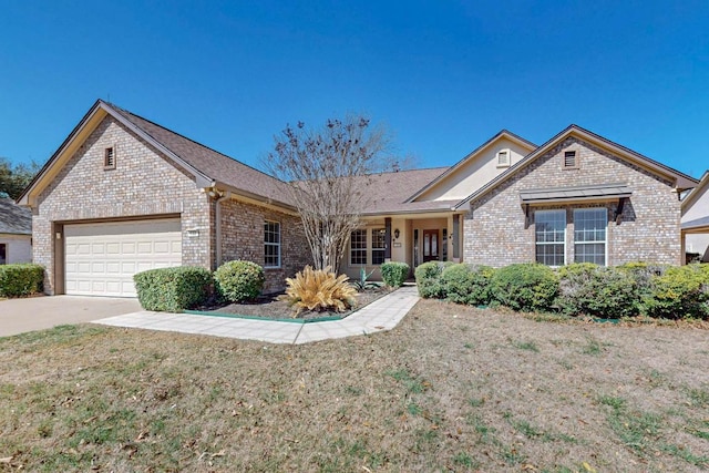 single story home with a front yard, brick siding, concrete driveway, and an attached garage