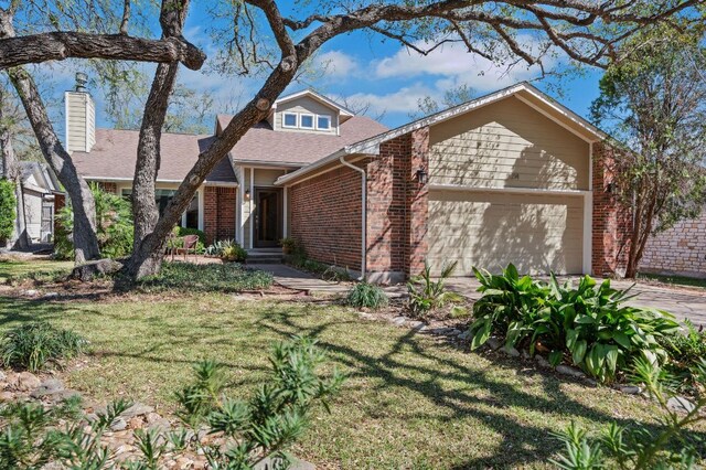 11214 Stormy Ridge Rd, Austin, TX 78739 - view of front of property featuring brick siding, an attached garage, a front yard, a shingled roof, and a chimney