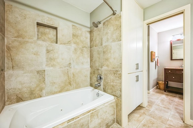 full bath with vanity, a combined bath / shower with jetted tub, and tile patterned floors
