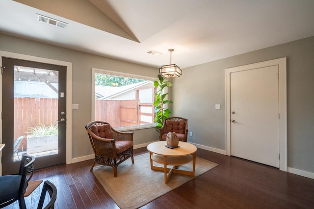 sitting room with vaulted ceiling, wood finished floors, and baseboards