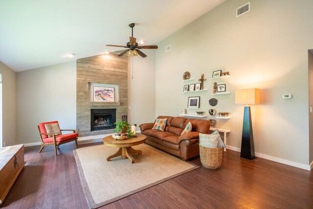 11214 Stormy Ridge Rd, Austin, TX 78739 - living room featuring ceiling fan, dark wood-style flooring, a tiled fireplace, and high vaulted ceiling