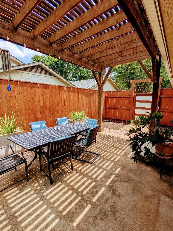 view of patio with outdoor dining space, a fenced backyard, and a pergola