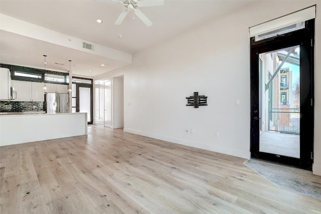 2525 S Lamar Blvd Unit 204, Austin, TX 78704 - unfurnished living room with light wood finished floors, ceiling fan, and recessed lighting