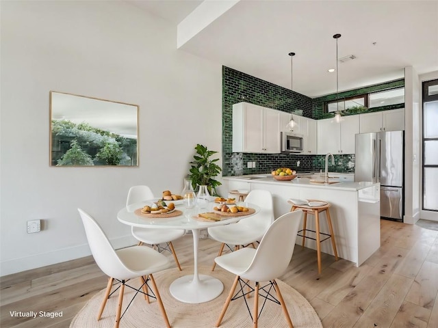 2525 S Lamar Blvd Unit 204, Austin, TX 78704 - dining area featuring light wood finished floors