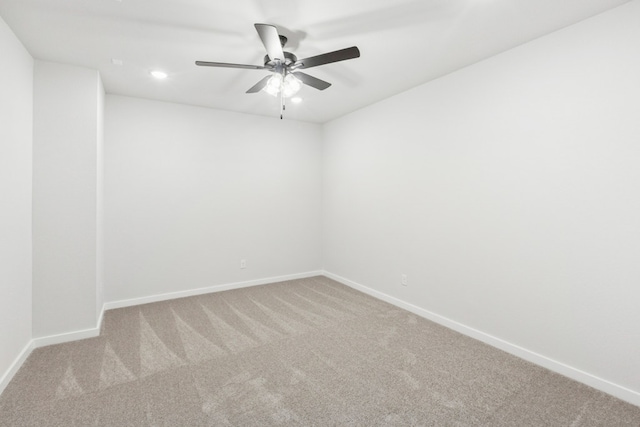 carpeted empty room featuring a ceiling fan, baseboards, and recessed lighting
