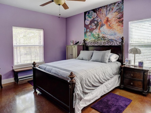 bedroom featuring ceiling fan, baseboards, and multiple windows