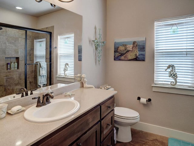 bathroom featuring toilet, a stall shower, baseboards, and vanity