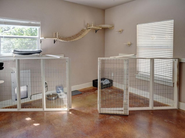 unfurnished bedroom featuring concrete floors and baseboards
