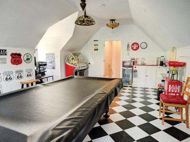 playroom featuring a sink, tile patterned floors, and lofted ceiling