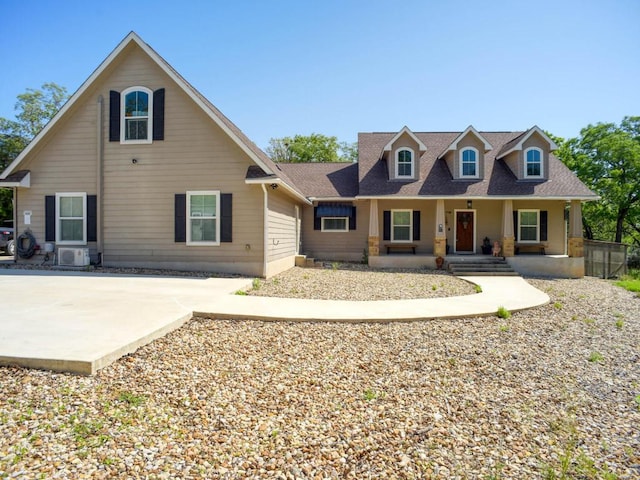 view of front of home featuring a patio area, a shingled roof, and covered porch