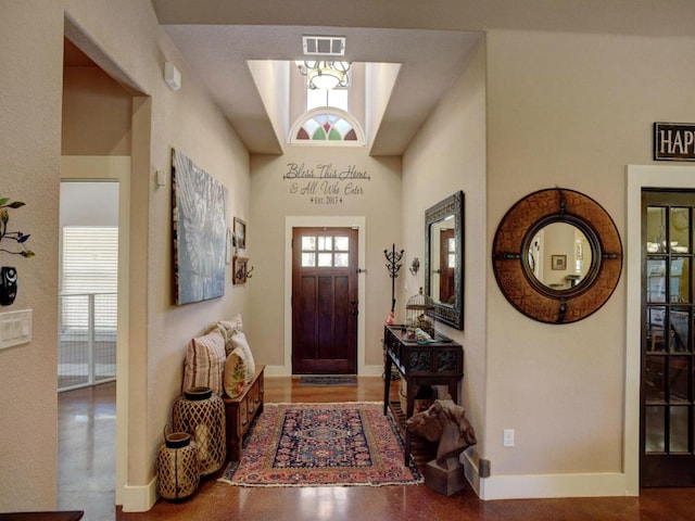 foyer with baseboards and visible vents