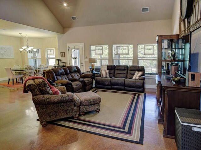 living area featuring visible vents, baseboards, high vaulted ceiling, and a notable chandelier