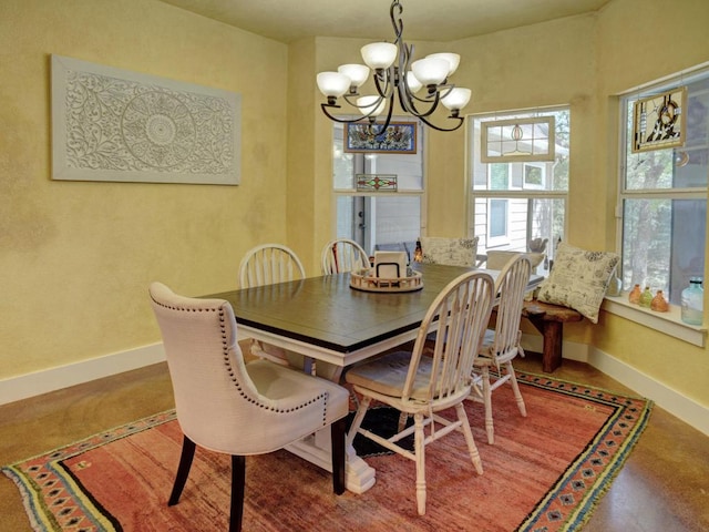 dining room with baseboards and a notable chandelier