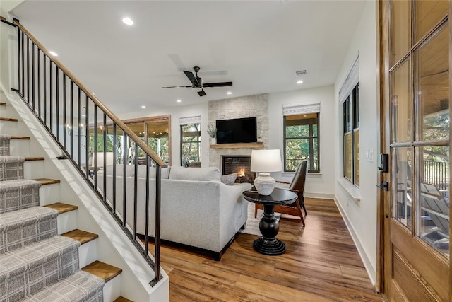 7601 Bar K Ranch Rd, Lago Vista, TX 78645 - living area featuring wood finished floors, a large fireplace, plenty of natural light, stairway, and recessed lighting