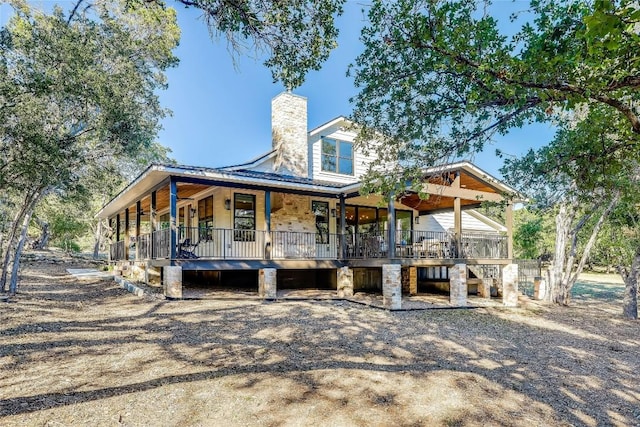 7601 Bar K Ranch Rd, Lago Vista, TX 78645 - view of front facade with covered porch, a chimney, and stairs