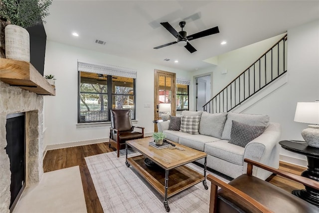 7601 Bar K Ranch Rd, Lago Vista, TX 78645 - living room with wood finished floors, healthy amount of natural light, recessed lighting, a ceiling fan, and a stone fireplace