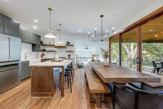 7601 Bar K Ranch Rd, Lago Vista, TX 78645 - kitchen featuring open shelves, light countertops, light wood-type flooring, a chandelier, and dishwashing machine
