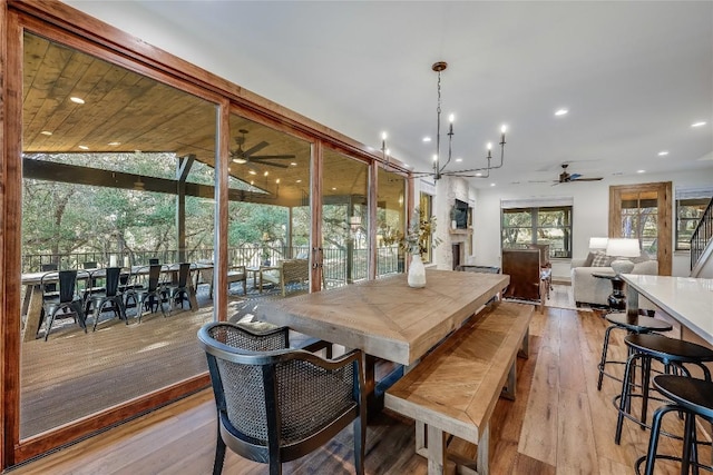 7601 Bar K Ranch Rd, Lago Vista, TX 78645 - dining area with a ceiling fan, recessed lighting, light wood-type flooring, and a chandelier