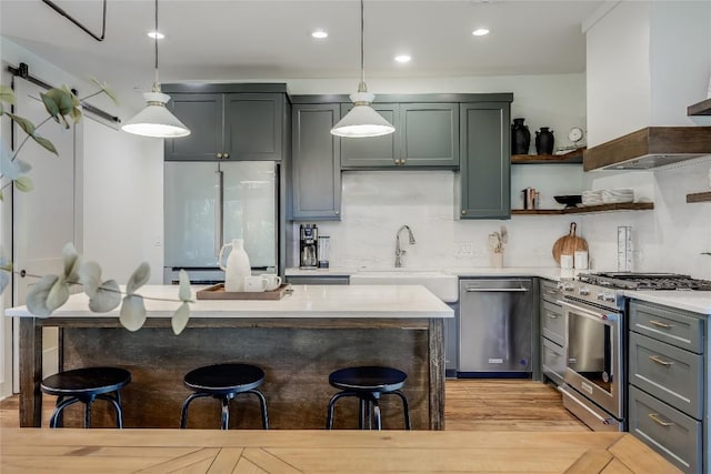 7601 Bar K Ranch Rd, Lago Vista, TX 78645 - kitchen featuring appliances with stainless steel finishes, a breakfast bar area, pendant lighting, and recessed lighting