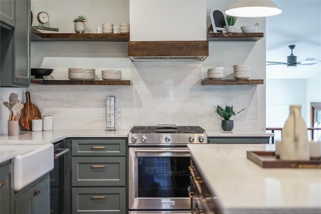 7601 Bar K Ranch Rd, Lago Vista, TX 78645 - kitchen featuring open shelves, gas stove, wall chimney exhaust hood, tasteful backsplash, and a ceiling fan
