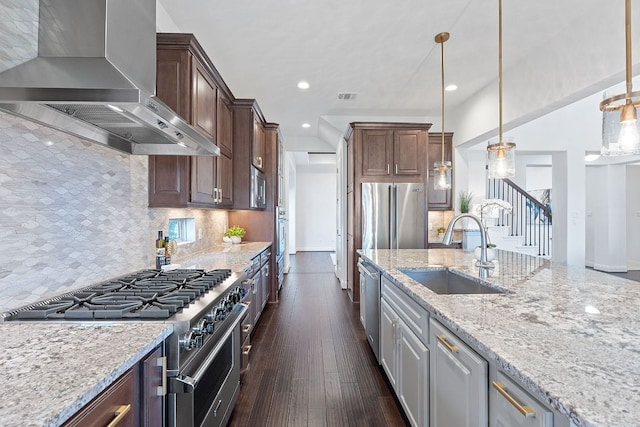 510 Doe Whisper Way, Austin, TX 78738 - kitchen with wall chimney exhaust hood, stainless steel appliances, light stone countertops, recessed lighting, and tasteful backsplash