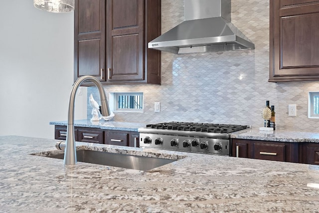 510 Doe Whisper Way, Austin, TX 78738 - kitchen featuring wall chimney range hood, dark brown cabinetry, and decorative backsplash