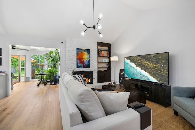 1004 Cripple Creek Dr, Austin, TX 78758 - living area featuring a fireplace, high vaulted ceiling, an inviting chandelier, and light wood finished floors