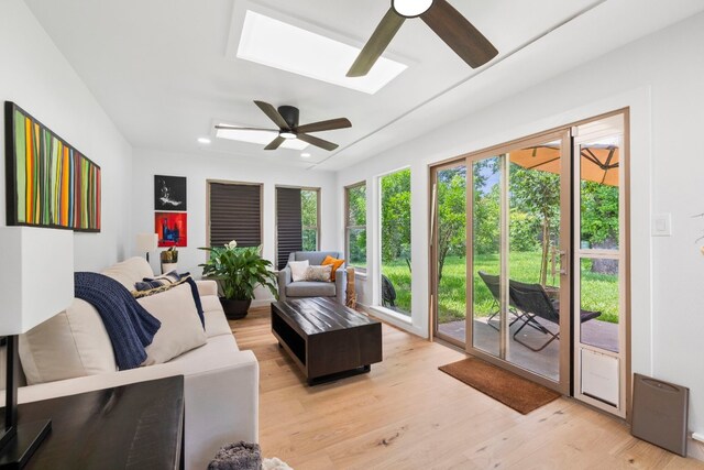 1004 Cripple Creek Dr, Austin, TX 78758 - living area featuring a ceiling fan, a skylight, and light wood-style floors