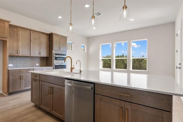 kitchen with light countertops, visible vents, a sink, and appliances with stainless steel finishes
