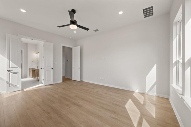 unfurnished bedroom featuring baseboards, light wood-style flooring, visible vents, and recessed lighting
