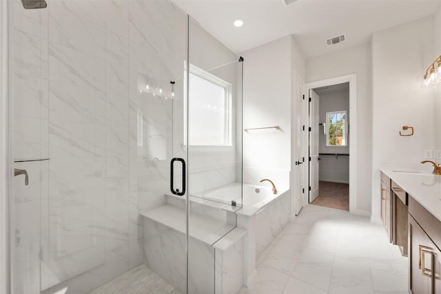 bathroom featuring a garden tub, a marble finish shower, vanity, baseboards, and visible vents