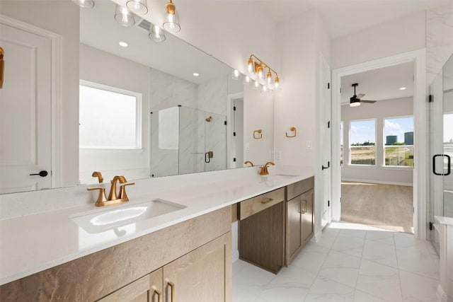 full bath with a ceiling fan, a marble finish shower, a sink, and marble finish floor