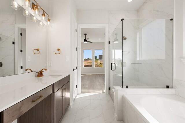 full bath featuring a bath, a marble finish shower, a ceiling fan, marble finish floor, and vanity