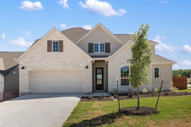 traditional-style home with stone siding, a shingled roof, a front lawn, and concrete driveway